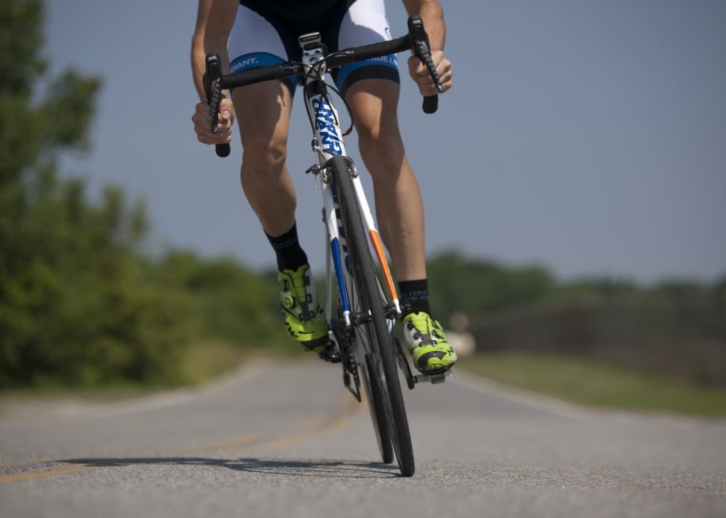 a male cyclist riding on a roadway