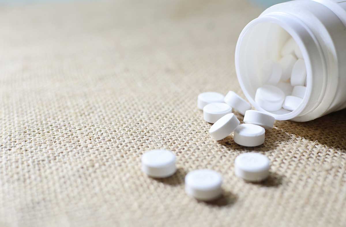 acetaminophen tablets pored from a bottle onto a counter