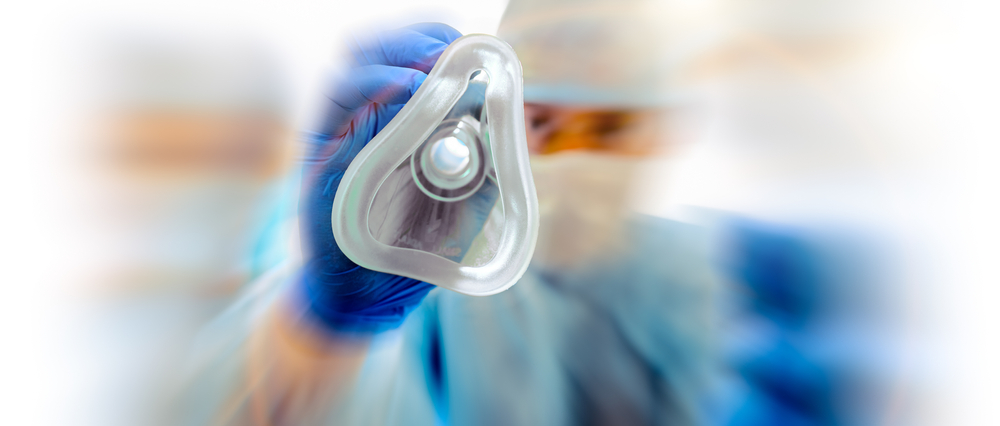 blurred image of an anesthesiologist with an oxygen mask for patient