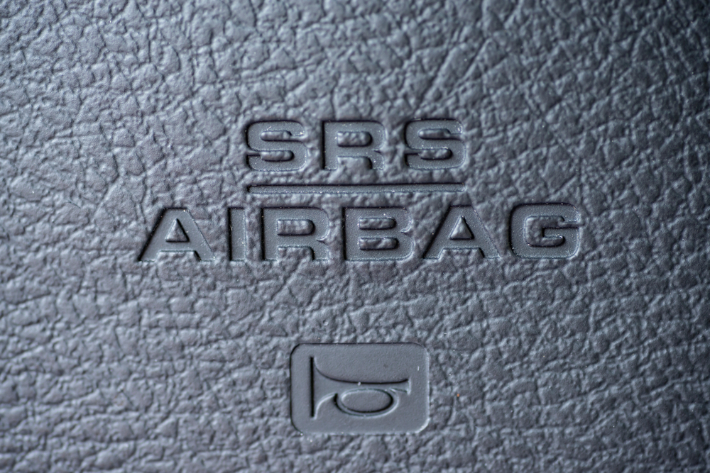 closeup of steering wheel srs airbag and horn