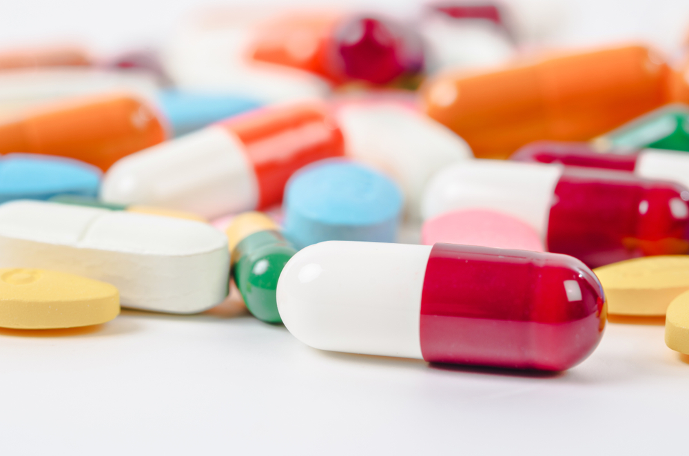 generic prescription pills, tablets and capsules closeup on a white background