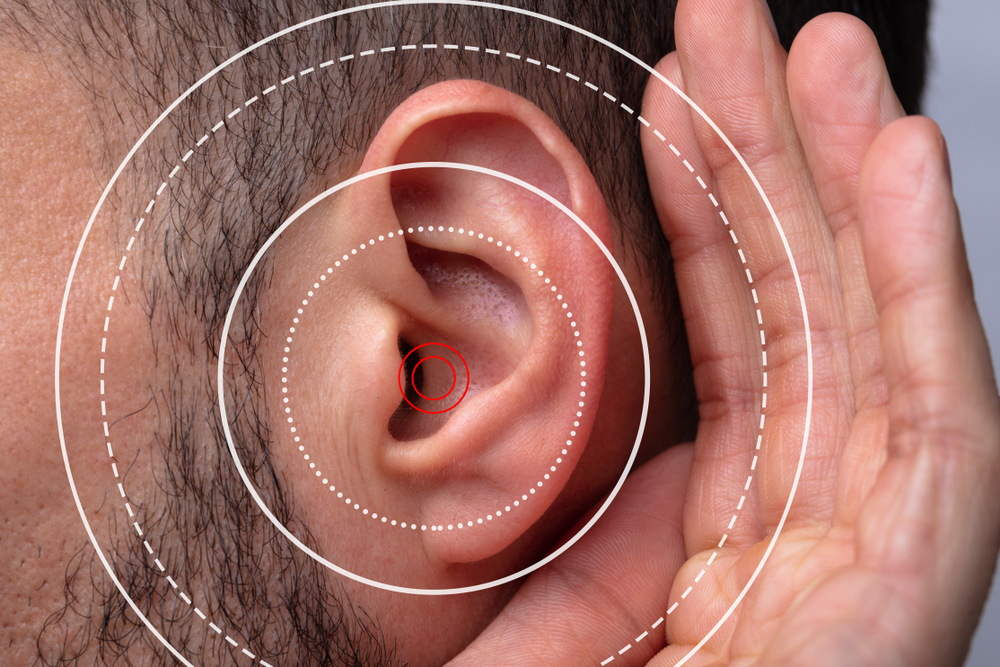 closeup of a man's ear with hearing loss graphics