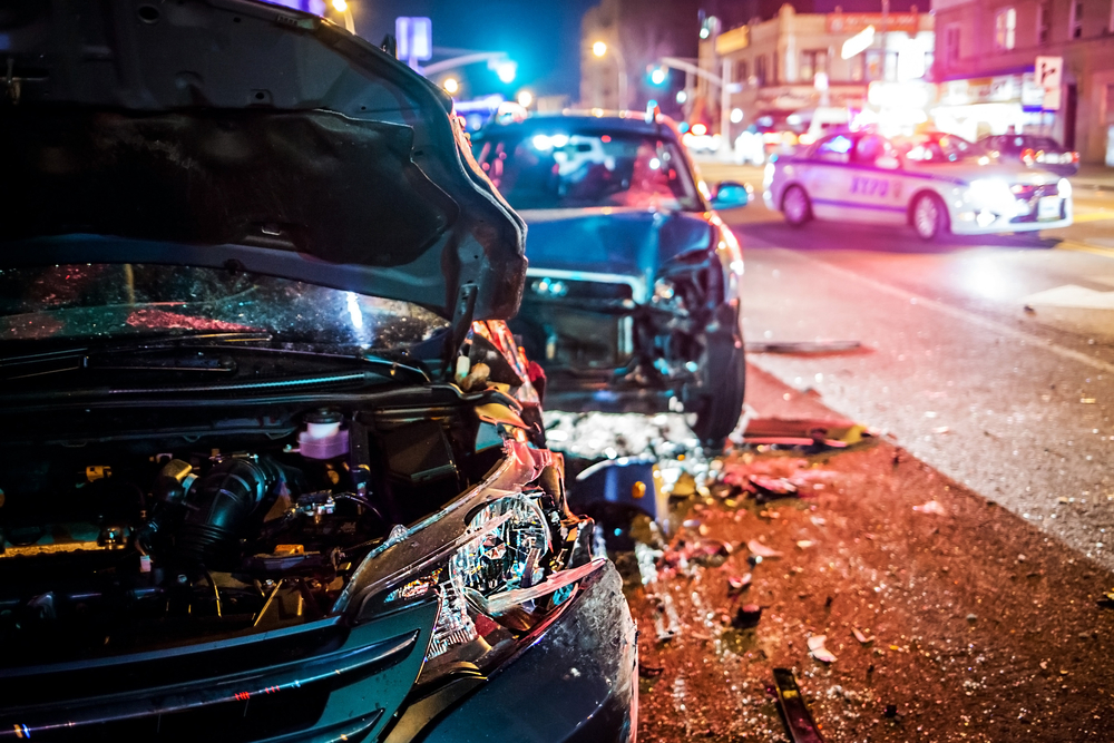 Multiple car crash on road with police at night in the city