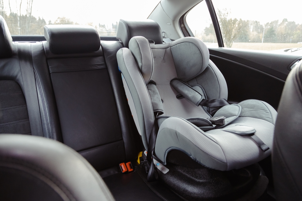 an empty car seat for a child in the backseat of a vehicle