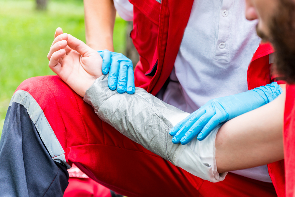 emergency medical services treating a man with a burn on his arm