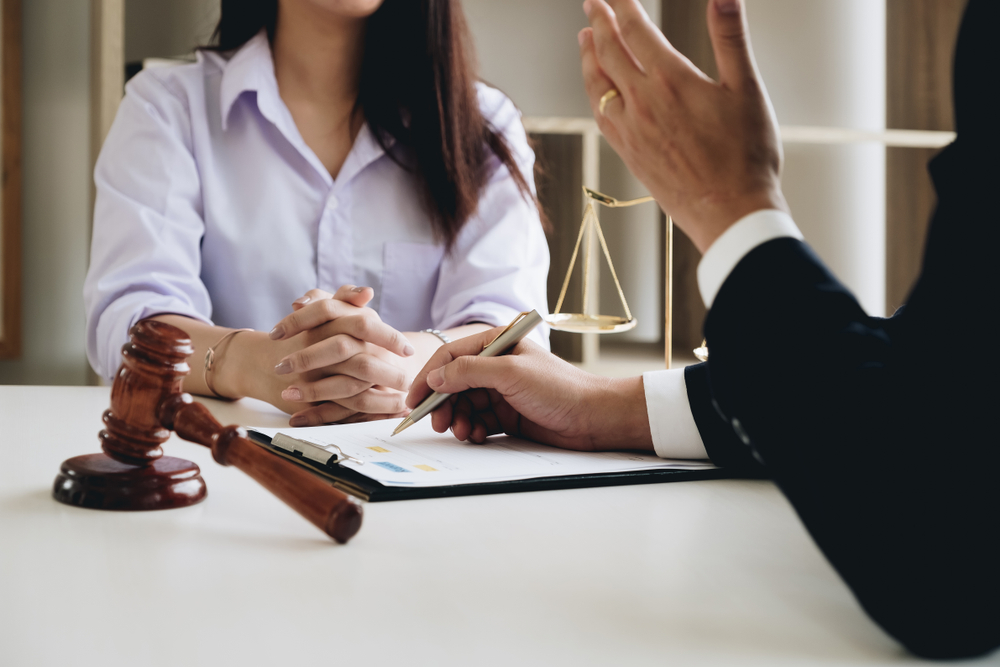 A lawyer present a woman with legal paperwork