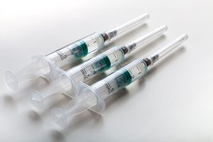 Syringes on white table, prepared for injection